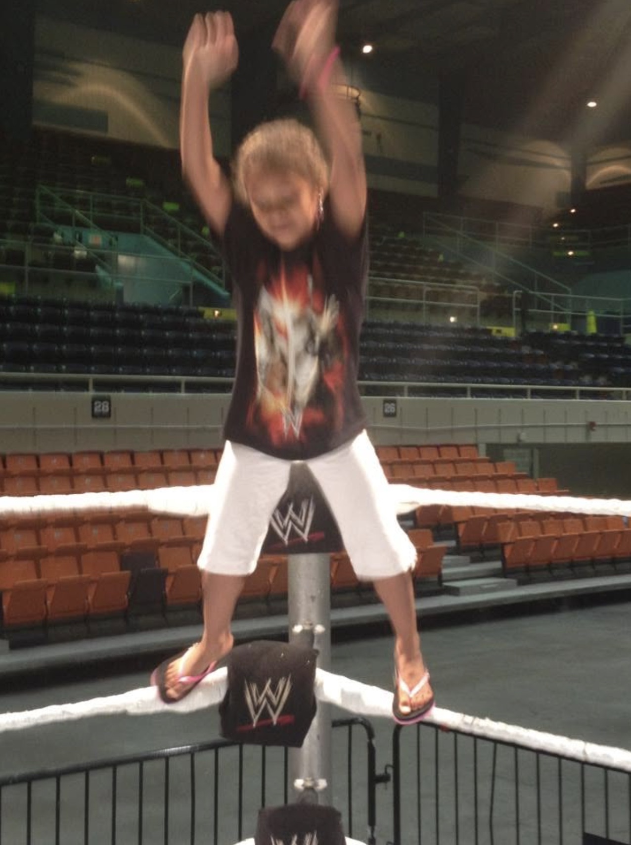 Kip's daughter jumping off the turnbuckle in an empty WWE arena
