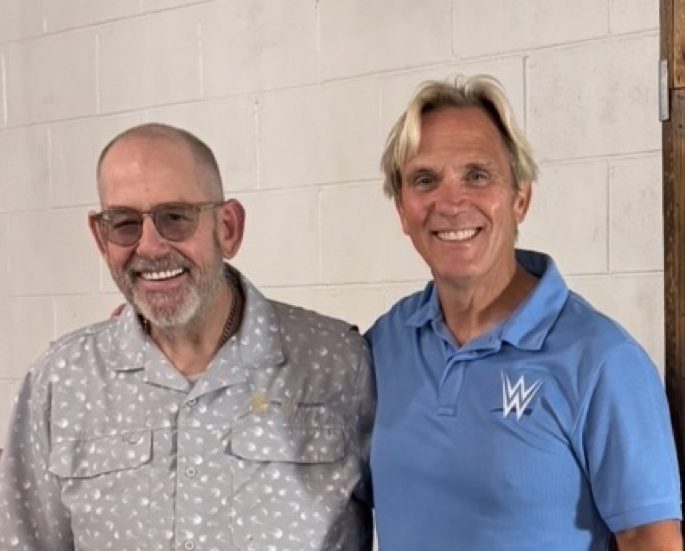 Close portrait of Charles Robinson in a WWE polo and Kip Lee at Savannah Bee Company, August 2026